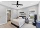 Bedroom featuring a ceiling fan, modern decor, and an attached bathroom at 13902 Messina Loop, Bradenton, FL 34211