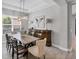 Elegant dining room with a modern chandelier, dining table set, and large buffet at 13902 Messina Loop, Bradenton, FL 34211