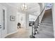 Inviting foyer featuring tiled floors, an elegant staircase, and views into the dining and office areas at 13902 Messina Loop, Bradenton, FL 34211