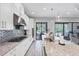 Bright kitchen with white cabinets, granite countertops, and stainless steel appliances, including a gas cooktop at 13902 Messina Loop, Bradenton, FL 34211