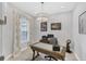 Modern office features stylish lighting, desk, neutral walls, and light colored floor at 13902 Messina Loop, Bradenton, FL 34211