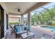 Spacious screened patio with brick pavers, outdoor seating, and a serene view of the pool at 13902 Messina Loop, Bradenton, FL 34211