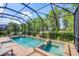 Inviting screened-in pool area with spa and lush landscaping at 13902 Messina Loop, Bradenton, FL 34211