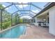 Beautiful screened-in pool area with brick pavers, lounge chairs, and covered patio at 13902 Messina Loop, Bradenton, FL 34211