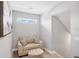 Sitting area featuring a comfortable armchair, ottoman, neutral walls, and natural light at 13902 Messina Loop, Bradenton, FL 34211