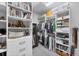 Walk-in closet with custom shelving, hanging racks, drawers, and plenty of storage space at 13902 Messina Loop, Bradenton, FL 34211