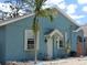 Charming blue exterior with white trim, complemented by a well-manicured yard and inviting front entrance at 1609 17Th W St, Bradenton, FL 34205