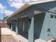 Charming exterior walkway featuring classic architectural columns, exterior lighting, and white window shutters at 1609 17Th W St, Bradenton, FL 34205