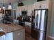 Modern kitchen with granite counters, stainless steel appliances, and an island with a sink at 1609 17Th W St, Bradenton, FL 34205