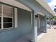Exterior walkway featuring classic architectural columns, exterior lighting, and white window shutters at 1609 17Th W St, Bradenton, FL 34205
