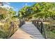 Scenic view of a wooden bridge surrounded by lush greenery in a park setting at 1721 8Th Street, Sarasota, FL 34236