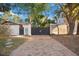 Property with a brick driveway and a large wooden gate at 1721 8Th Street, Sarasota, FL 34236