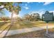 Scenic view of Gillespe Park, featuring an open green space with mature trees and walking paths in a serene setting at 1721 8Th Street, Sarasota, FL 34236