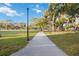 Walking path lined with mature trees and lush greenery in a peaceful park setting, perfect for leisurely strolls at 1721 8Th Street, Sarasota, FL 34236