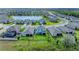 Aerial view of a home with a backyard, showcasing the surrounding community and a picturesque lake at 17669 Cantarina Cv, Bradenton, FL 34211