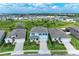 An aerial view of three well-maintained homes in a residential neighborhood at 17669 Cantarina Cv, Bradenton, FL 34211