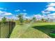 Spacious backyard with green lawn and black metal fence, perfect for outdoor activities at 17669 Cantarina Cv, Bradenton, FL 34211