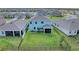 An aerial view of the backyard featuring a large grassy lawn and screened in patio, perfect for outdoor enjoyment at 17669 Cantarina Cv, Bradenton, FL 34211