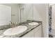Bathroom featuring double sinks with granite countertops and modern fixtures at 17669 Cantarina Cv, Bradenton, FL 34211
