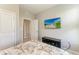 Clean bedroom with a bed, TV on wall, and easy access to the ensuite bathroom at 17669 Cantarina Cv, Bradenton, FL 34211