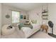 Bedroom with bright window, decorative shelving, and carpeted floors at 17669 Cantarina Cv, Bradenton, FL 34211