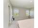 Bright bedroom featuring neutral tones, two windows, and a view of the neighborhood at 17669 Cantarina Cv, Bradenton, FL 34211