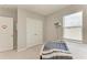 Bedroom featuring neutral tones, a window, and a mounted projector at 17669 Cantarina Cv, Bradenton, FL 34211