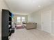 Upstairs bonus room with carpeting, media center, and a comfortable sofa at 17669 Cantarina Cv, Bradenton, FL 34211