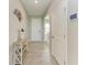 Bright entryway featuring neutral tones, tiled flooring, and stylish decor creating a welcoming ambiance at 17669 Cantarina Cv, Bradenton, FL 34211