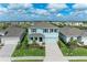 Charming two-story home featuring light blue siding, dark blue shutters, and a well-manicured lawn at 17669 Cantarina Cv, Bradenton, FL 34211