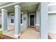Inviting front porch with stately columns and decorative touches, leading to the home's entrance at 17669 Cantarina Cv, Bradenton, FL 34211