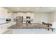 Bright kitchen features a large island with granite countertop and stainless steel appliances at 17669 Cantarina Cv, Bradenton, FL 34211