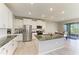 Modern kitchen with stainless steel appliances, granite countertops, and a large kitchen island at 17669 Cantarina Cv, Bradenton, FL 34211