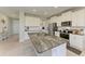 Open kitchen with granite countertops, stainless steel appliances, and center island for modern functionality at 17669 Cantarina Cv, Bradenton, FL 34211