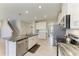 Bright kitchen features a large island with granite countertop and stainless steel appliances at 17669 Cantarina Cv, Bradenton, FL 34211