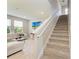 Bright living room with a staircase, comfortable sofa, and television at 17669 Cantarina Cv, Bradenton, FL 34211