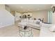 Spacious living room with modern furnishings, open layout, and a seamless flow to the kitchen and dining areas at 17669 Cantarina Cv, Bradenton, FL 34211