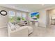 Inviting living room with neutral tones, large windows, stylish decor, and comfortable seating at 17669 Cantarina Cv, Bradenton, FL 34211
