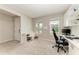 Bright office featuring dual desks, built-in cabinets, and natural light ideal for a productive work environment at 17669 Cantarina Cv, Bradenton, FL 34211