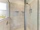 Walk-in shower featuring modern tile and glass door at 17669 Cantarina Cv, Bradenton, FL 34211