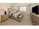 Comfortable bedroom with neutral tones, a large window, and stylish nightstands at 23572 Awabuki Dr # 202, Venice, FL 34293