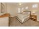 Comfortable bedroom featuring neutral colors, ceiling fan, and light wood furniture at 23572 Awabuki Dr # 202, Venice, FL 34293