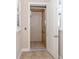 A convenient in-home elevator features safety bar, lighting, and tiled floors at 23572 Awabuki Dr # 202, Venice, FL 34293