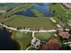 Aerial view of Sarasota National golf course showing the green, sand traps, and surrounding lakes at 23572 Awabuki Dr # 202, Venice, FL 34293