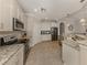 Bright kitchen with granite countertops, stainless appliances, and tiled floors at 23572 Awabuki Dr # 202, Venice, FL 34293