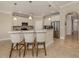 The kitchen has granite countertops, white cabinetry, and a breakfast bar at 23572 Awabuki Dr # 202, Venice, FL 34293