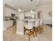 Spacious kitchen features granite countertops, stainless steel appliances, and barstool seating at 23572 Awabuki Dr # 202, Venice, FL 34293