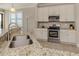 Modern kitchen with granite countertops, stainless steel appliances, and a double basin sink at 23572 Awabuki Dr # 202, Venice, FL 34293