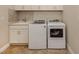 Efficient laundry room with modern washer and dryer, plus built-in cabinets at 23572 Awabuki Dr # 202, Venice, FL 34293