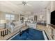 The living room features neutral tones, tile floors, and an open concept design at 23572 Awabuki Dr # 202, Venice, FL 34293